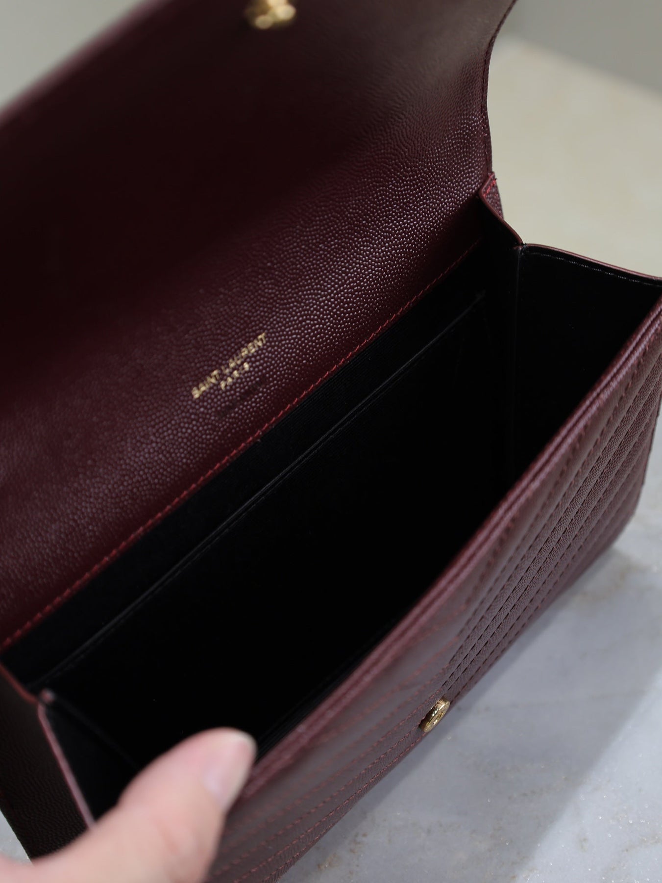 CASSANDRE CLUTCH 21 IN BORDEAUX RED LAMBSKIN GOLD HARDWARE