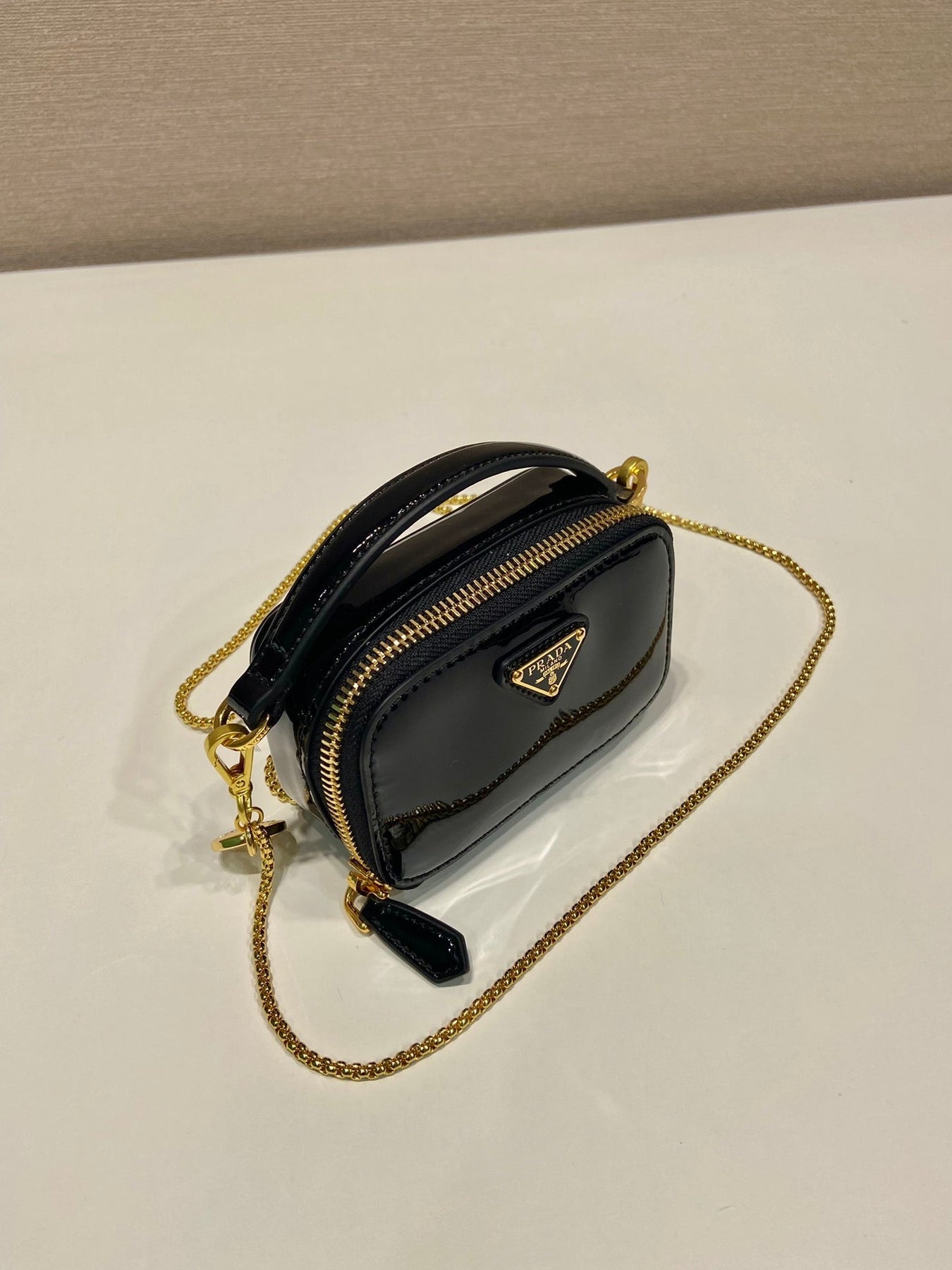 MINI HAND BAG 11 WITH GOLD STRAP IN BLACK PATENT CALFSKIN