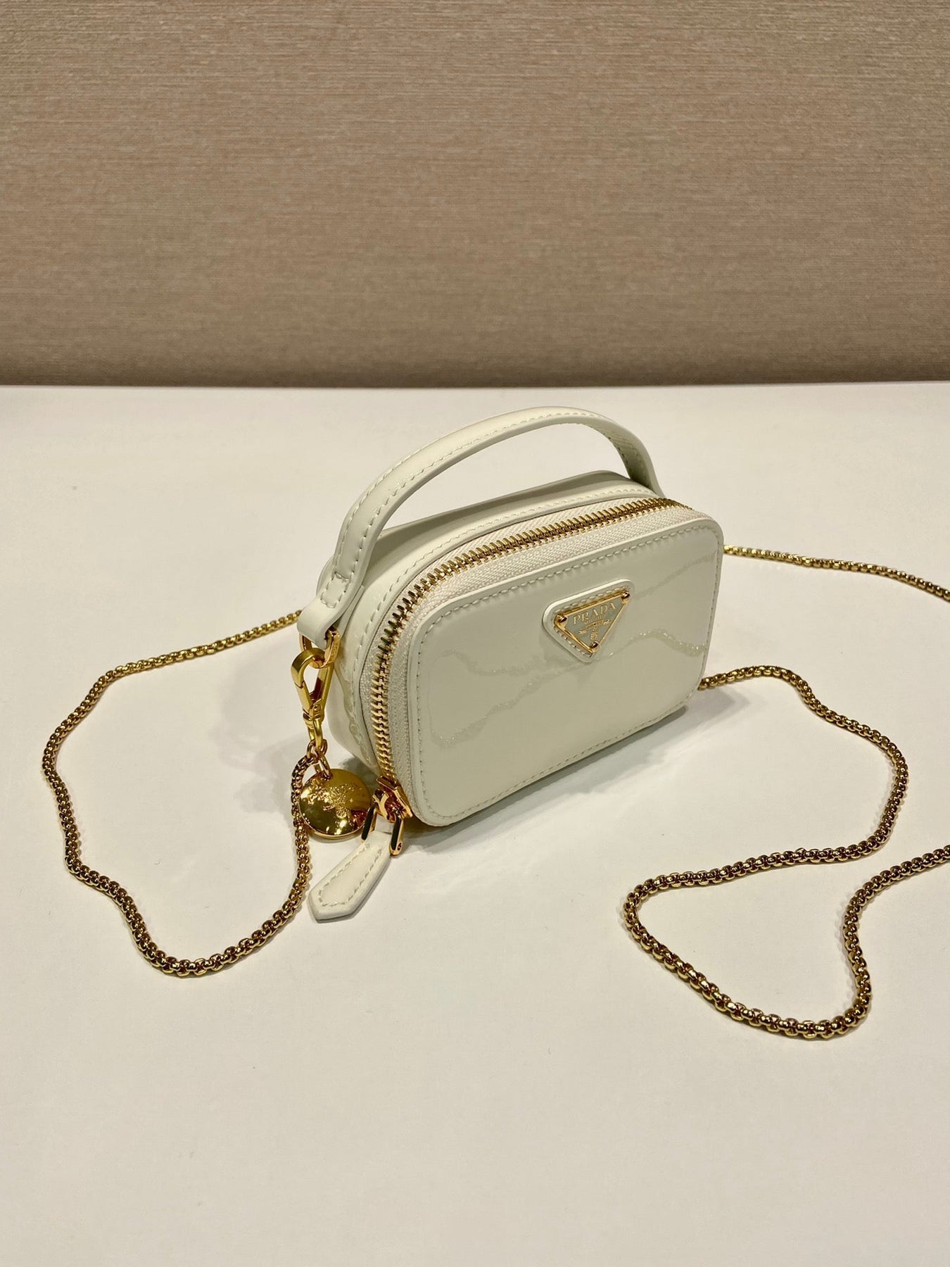 MINI HAND BAG 11 WITH GOLD STRAP IN WHITE PATENT CALFSKIN