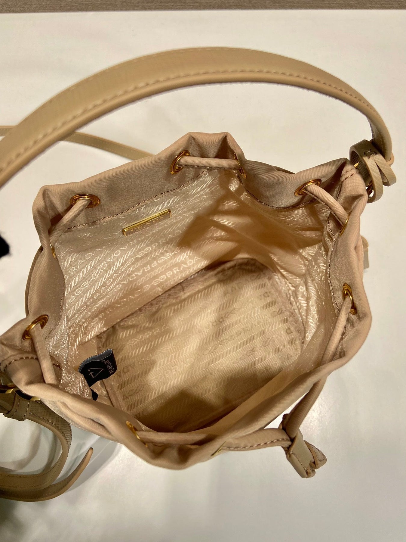 BUCKET BAG 19 IN BEIGE RE-NYLON AND SAFFIANO LEATHER HANDLE
