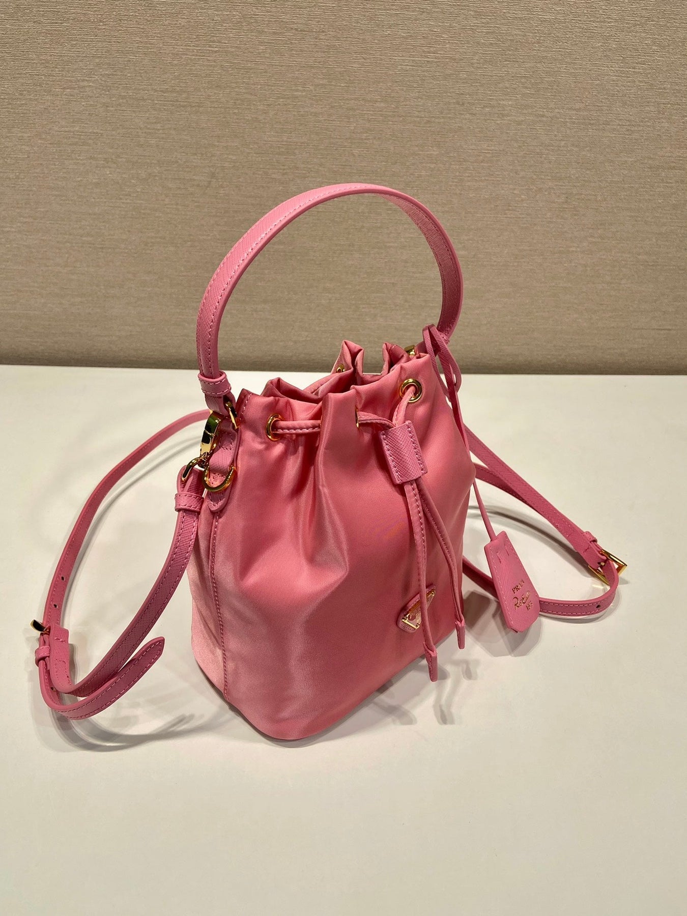 BUCKET BAG 19 IN CANDY PINK RE-NYLON AND SAFFIANO LEATHER HANDLE