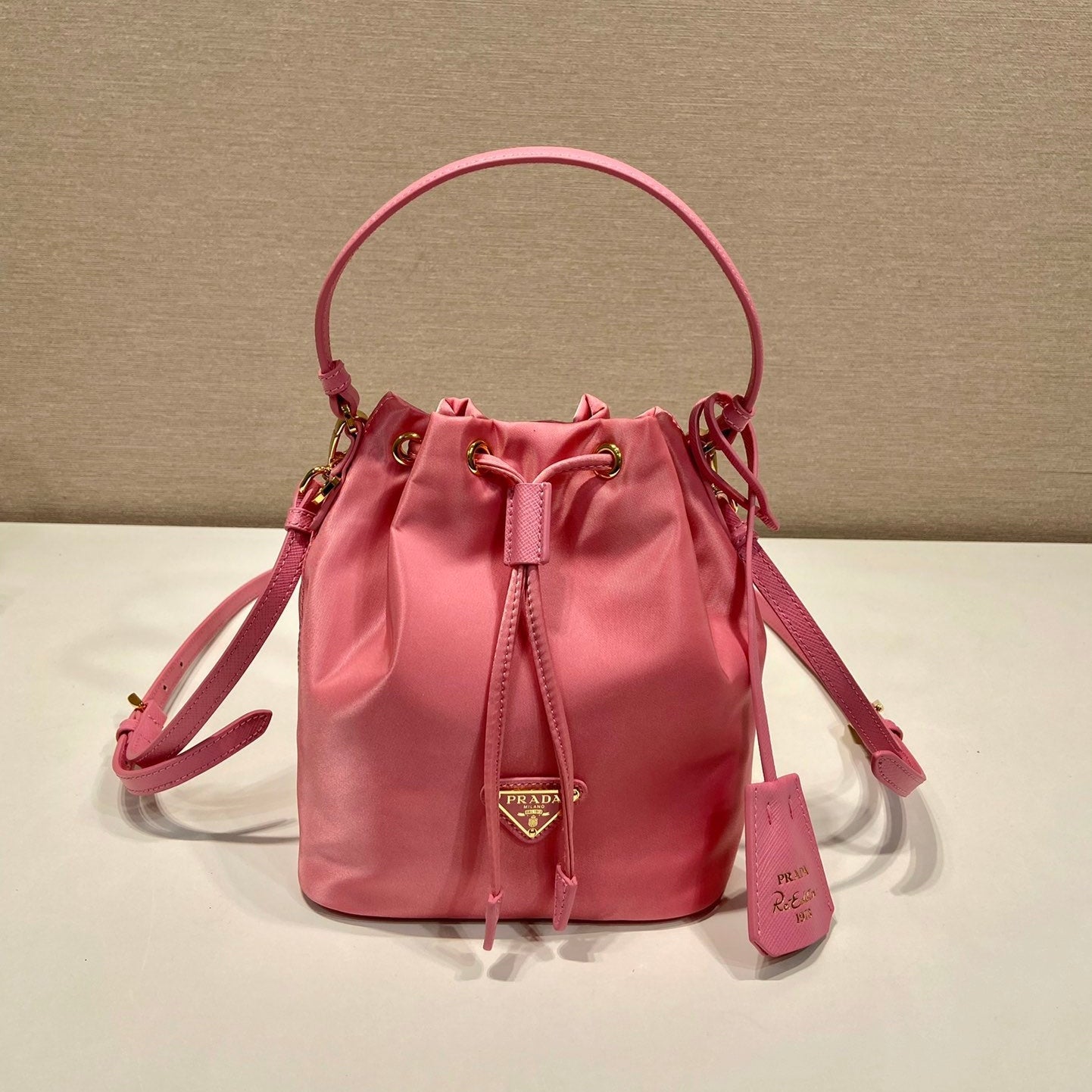 BUCKET BAG 19 IN CANDY PINK RE-NYLON AND SAFFIANO LEATHER HANDLE