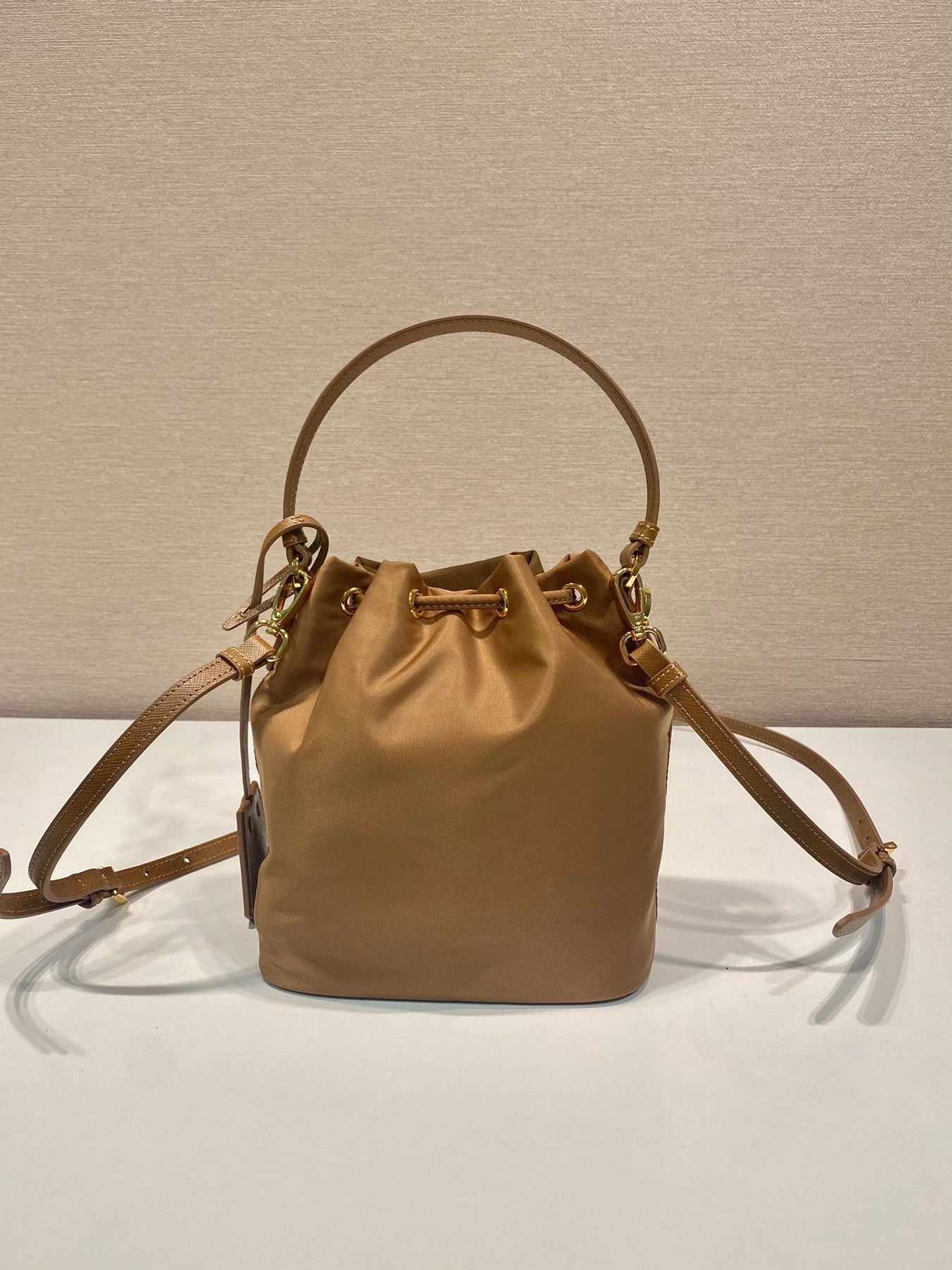 BUCKET BAG 19 IN RUSSET BROWN RE-NYLON AND CALFSKIN HANDLE