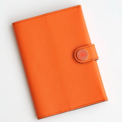 HERM R.M.S Passport Holder in Orange Evercolor Calfskin