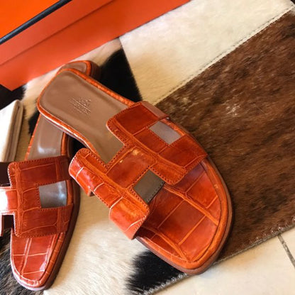 HERM Oran Slide Sandals In Orange Shiny Niloticus Crocodile Skin