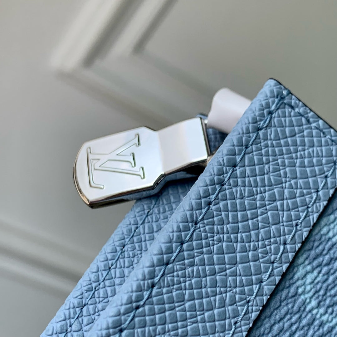 POCHETTE VOYAGE 26 IN LIGHT BLUE MONOGRAM ECLIPSE CALFSKIN