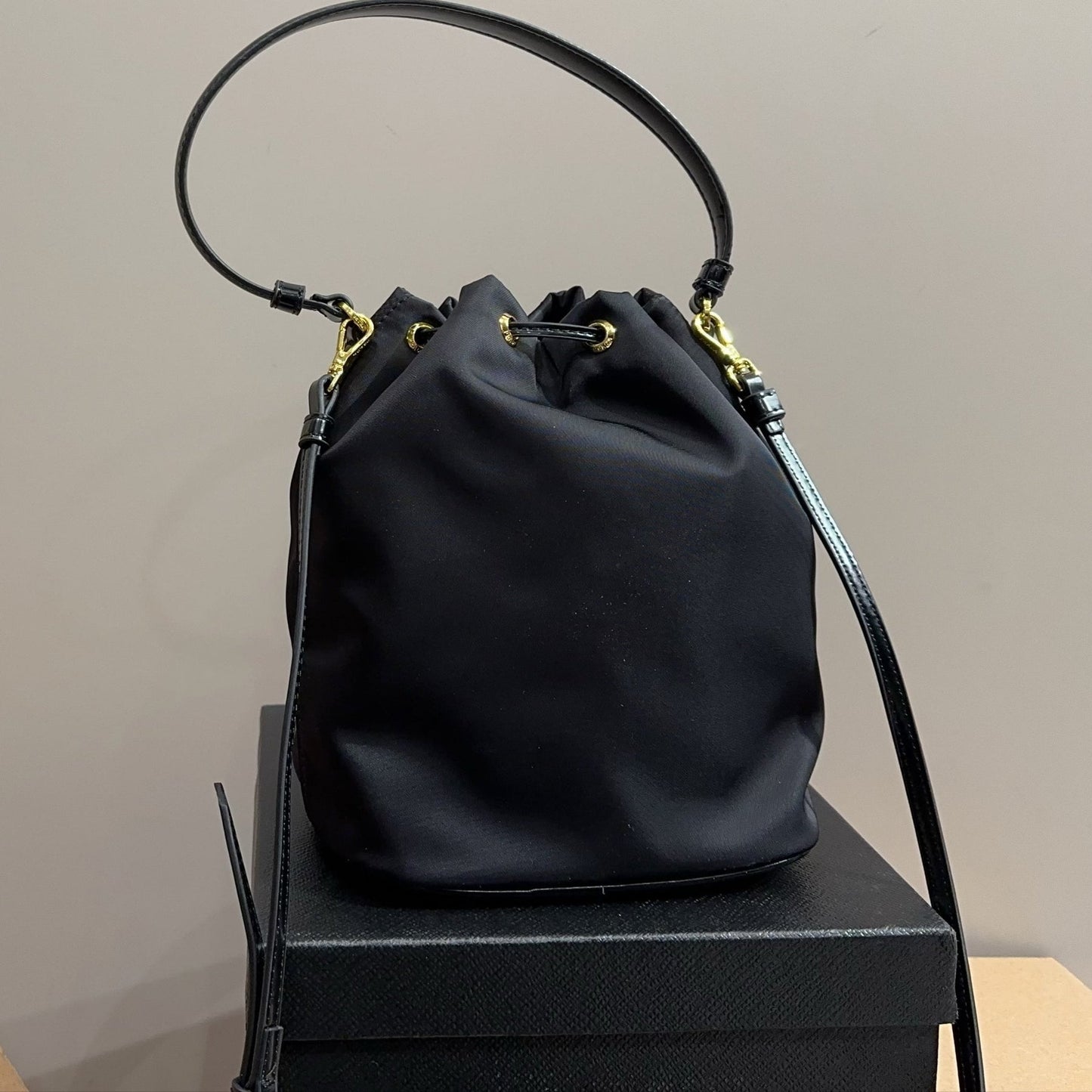 BUCKET BAG 22 IN BLACK RE-NYLON AND CALFSKIN HANDLE