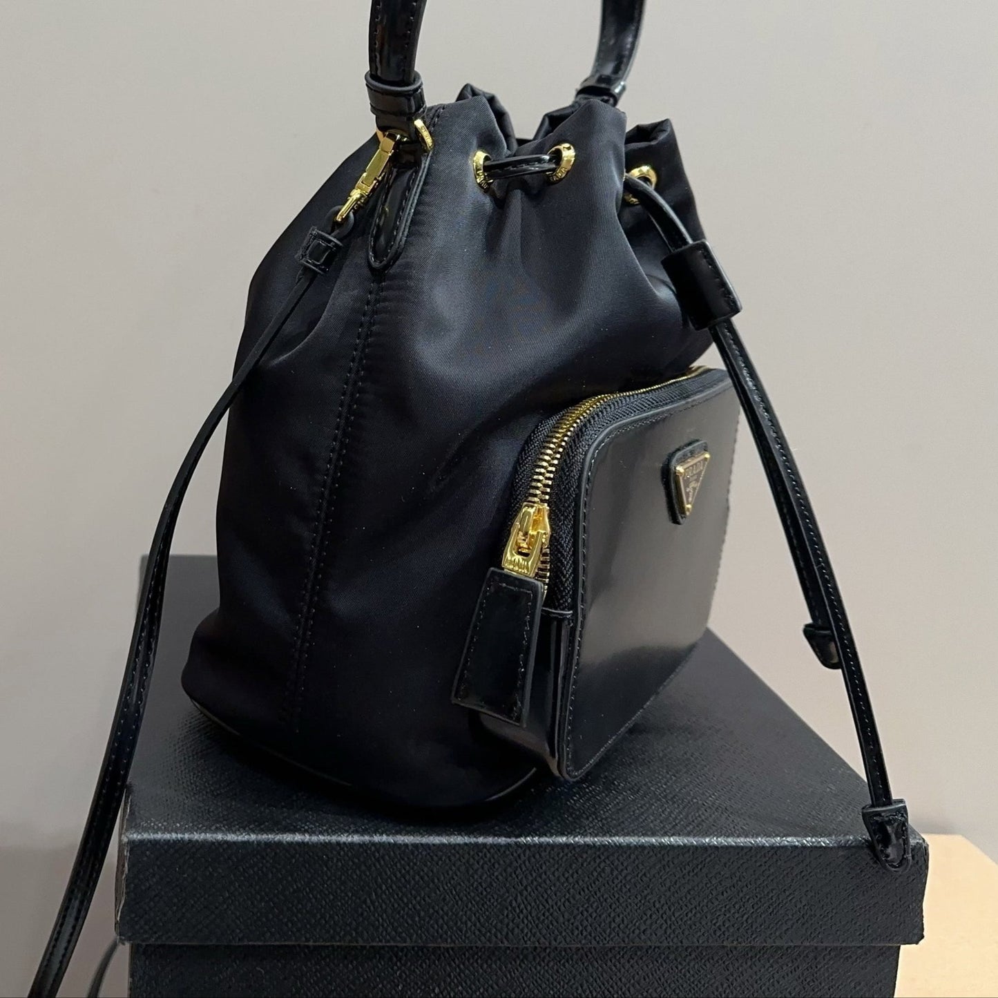 BUCKET BAG 22 IN BLACK RE-NYLON AND CALFSKIN HANDLE
