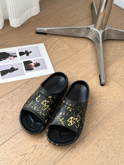 POOL GRAFFITI CROCS SLIDE SANDALS IN BLACK AND YELLOW RUBBER
