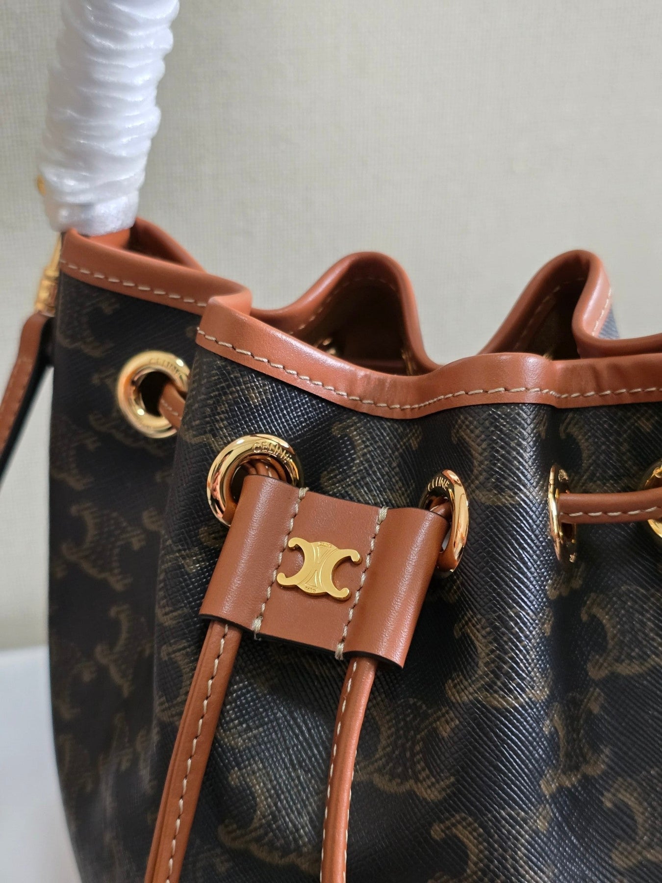 CLARA BAG 19 IN BLACK TRIOMPHE CANVAS AND BROWN CALFSKIN TRIM