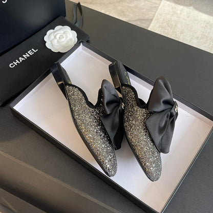 BIG BOW FLAT MULE SANDALS IN BLACK SILK WITH GLITTER SEQUINS
