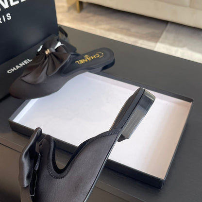 BIG BOW FLAT MULE SANDALS IN BLACK SILK