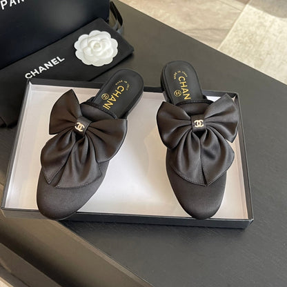 BIG BOW FLAT MULE SANDALS IN BLACK SILK