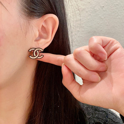 DOUBLE C STUD EARRINGS IN SILVER METAL WITH BLACK OUTLINE AND CRYSTALS INSIDE