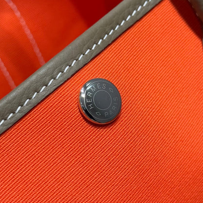 GARDEN PARTY 30CM IN ORANGE MINIMUM TOILETS COTTON CANVAS AND BROWN CALFSKIN