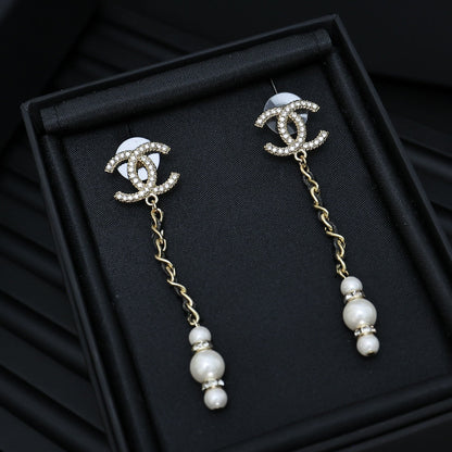 DOUBLE C CHAIN DETAIL EARRINGS IN GOLD METAL WITH LAMBSKIN TASSEL PEARL AND CRYSTAL LOGO
