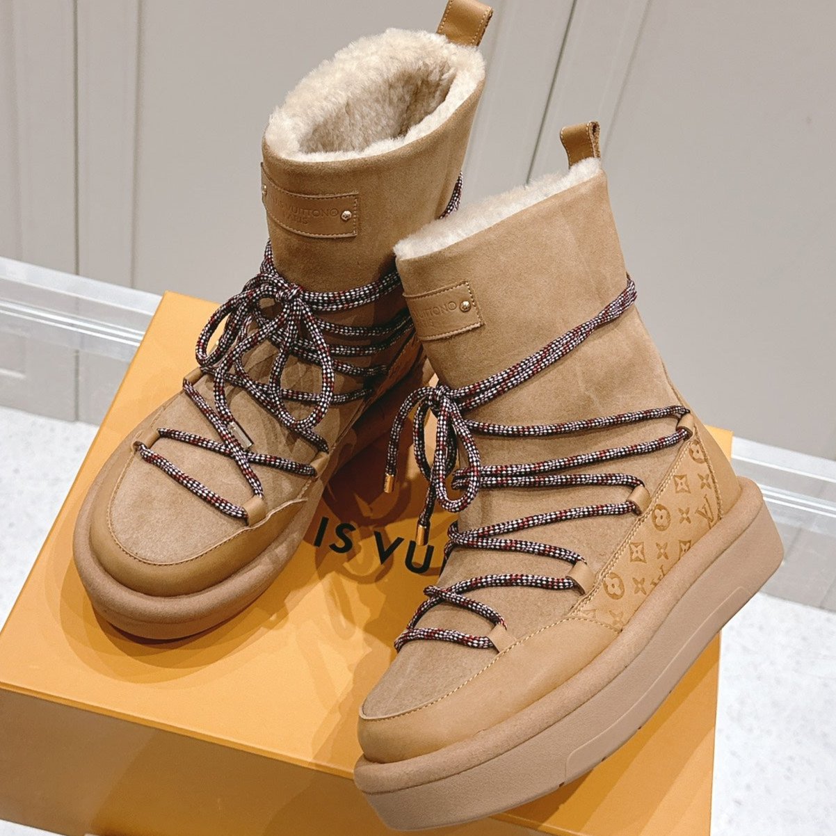 ASPEN PLATFORM ANKLE BOOT IN CIDER BROWN MONOGRAM DEBOSSED SUEDE AND SHEARLING