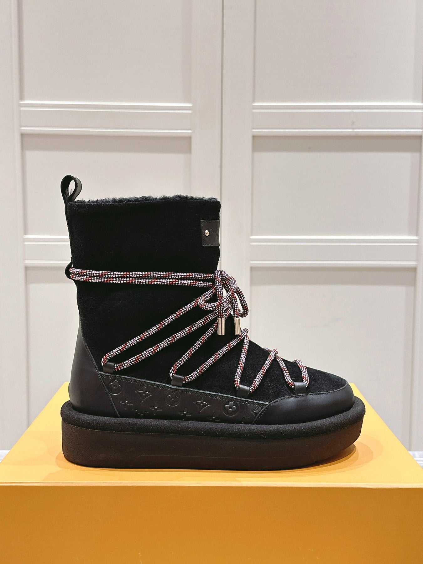 ASPEN PLATFORM ANKLE BOOT IN BLACK MONOGRAM DEBOSSED SUEDE AND SHEARLING
