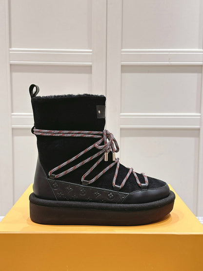 ASPEN PLATFORM ANKLE BOOT IN BLACK MONOGRAM DEBOSSED SUEDE AND SHEARLING
