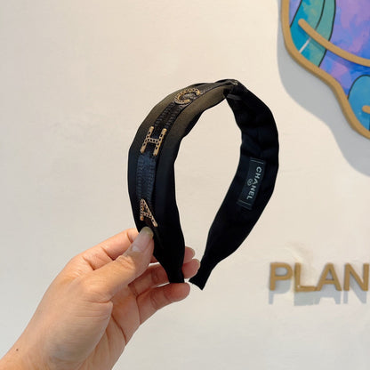 BLACK SILK HAIRBAND WITH GOLD LOGO 412441