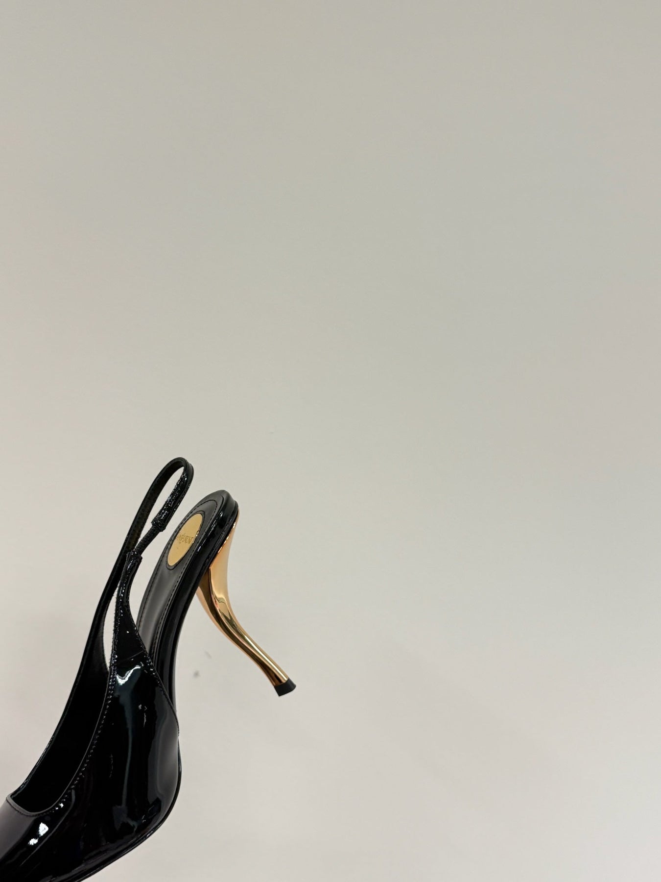 GREEN GEM-STUDDED SLINGBACK PUMPS IN BLACK PATENT CALFSKIN