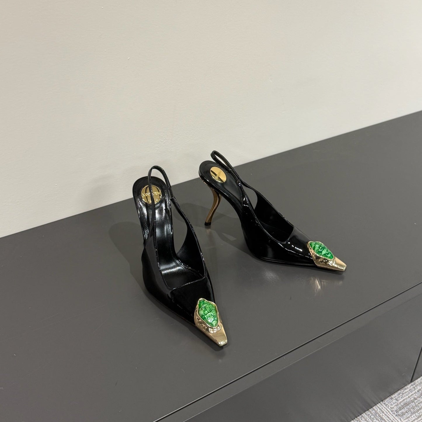 GREEN GEM-STUDDED SLINGBACK PUMPS IN BLACK PATENT CALFSKIN