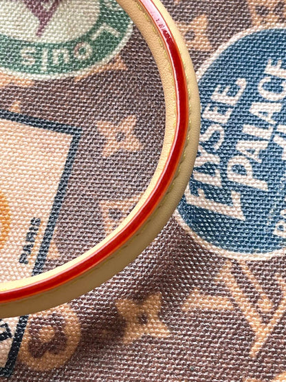 ONTHEGO VOYAGE 35 IN BROWN MONOGRAM CANVAS WITH VINTAGE HOTEL LABELS