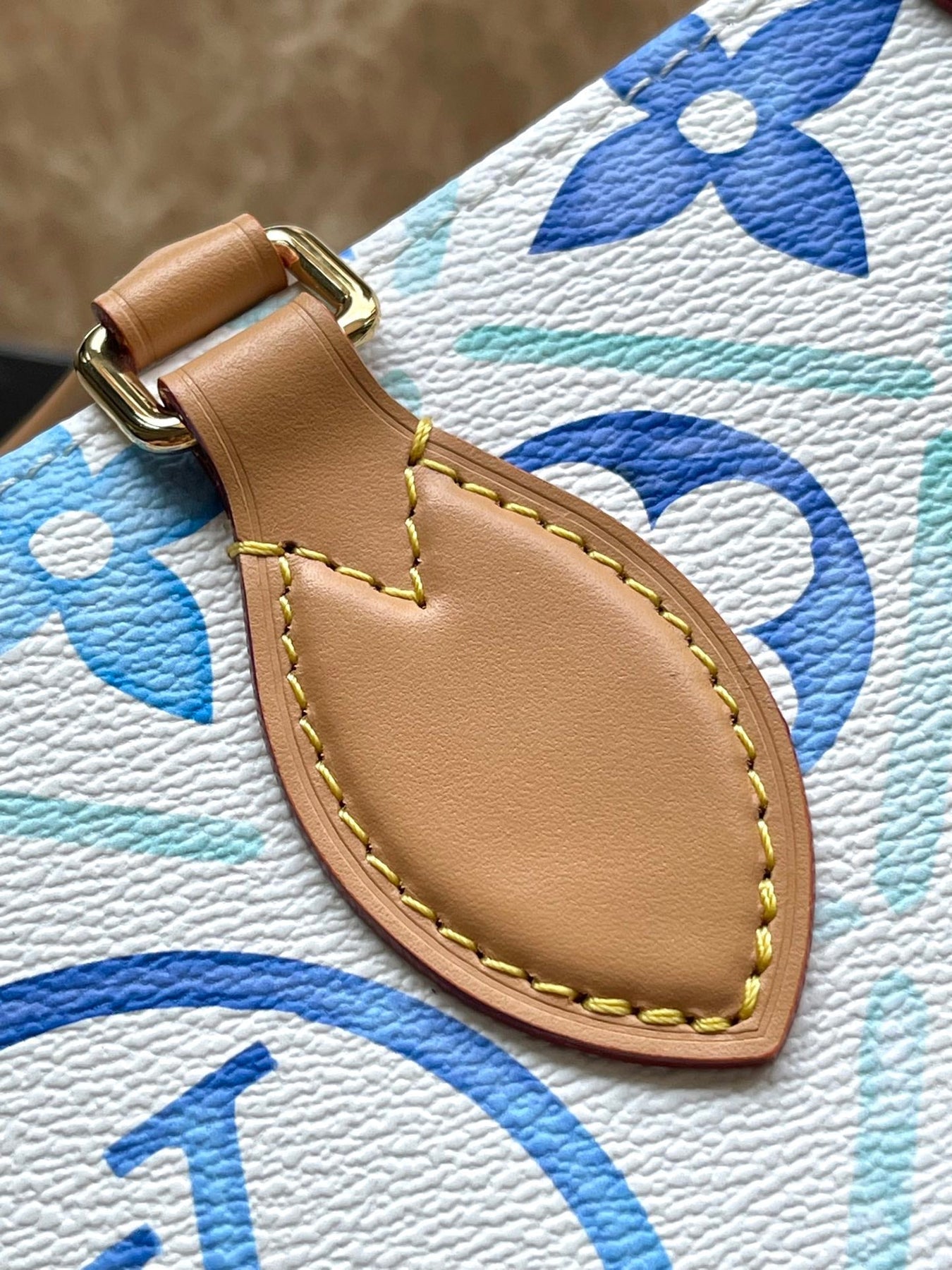 ONTHEGO EAST WEST 25 IN LAGOON BLUE MONOGRAM TILES CANVAS