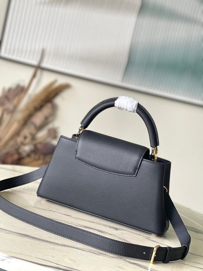 CAPUCINES EAST-WEST 33 IN BLACK CALFSKIN GOLD HARDWARE