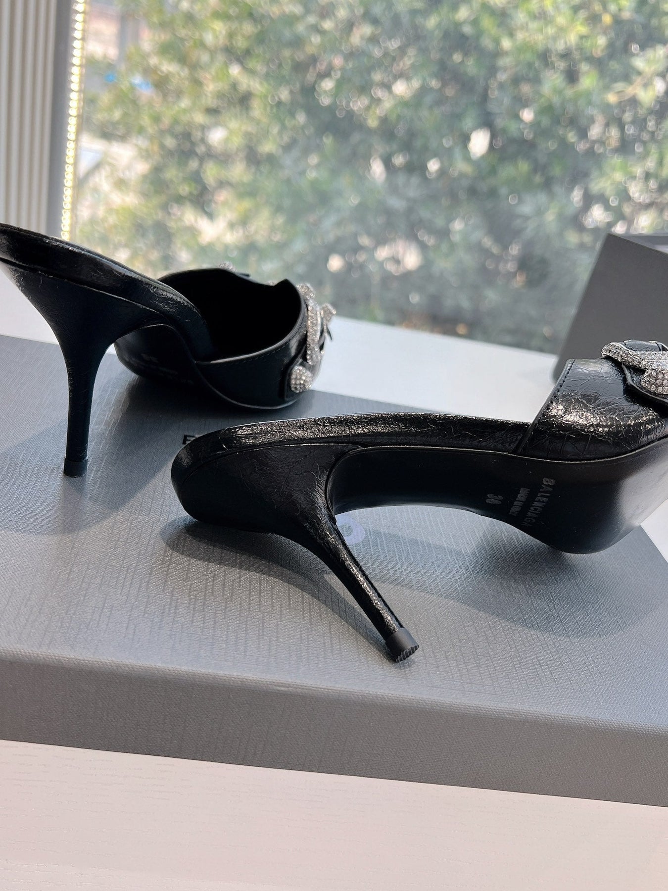 CRYSTAL BUCKLE BLACK WAX-OIL SHEEPSKIN HEELED MULES