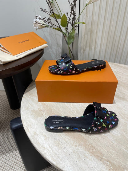 BOW FLAT MULES IN BLACK MONOGRAM LAMBSKIN