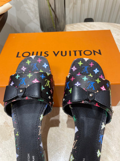 BOW FLAT MULES IN BLACK MONOGRAM LAMBSKIN