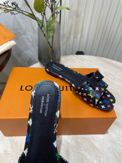 BOW FLAT MULES IN BLACK MONOGRAM LAMBSKIN