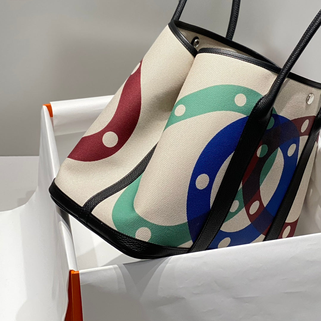 GARDEN PARTY 36 IN MULTICOLOR TOILE H CANVAS BLACK CALFSKIN OVERLAPPING POLKA RINGS PRINT