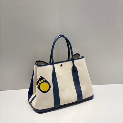 GARDEN PARTY 36 IN NAVY CREAM TOILE H CANVAS BLUE MARINE CALFSKIN ABSTRACT BEAR FACE PRINT