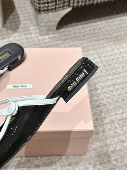 FLAT MULE IN BLACK AND WHITE PATENT CALFSKIN