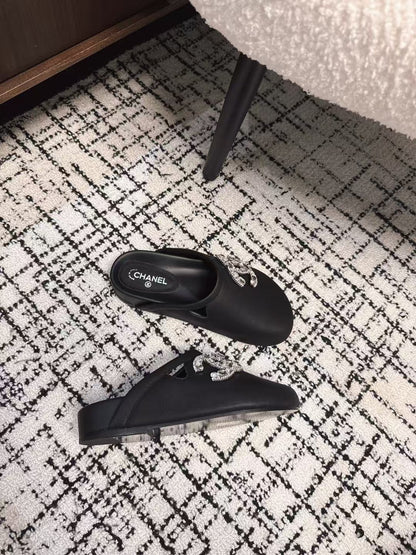 FLAT MULES IN BLACK CALFSKIN