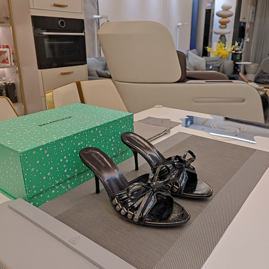 BOW-EMBELLISHED HIGH MULES IN BLACK SHEEPSKIN