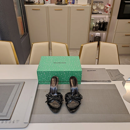 BOW-EMBELLISHED HIGH MULES IN BLACK SHEEPSKIN