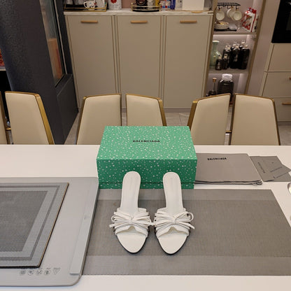 BOW-EMBELLISHED HIGH MULES IN WHITE SHEEPSKIN