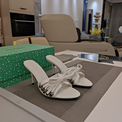 BOW-EMBELLISHED HIGH MULES IN WHITE SHEEPSKIN