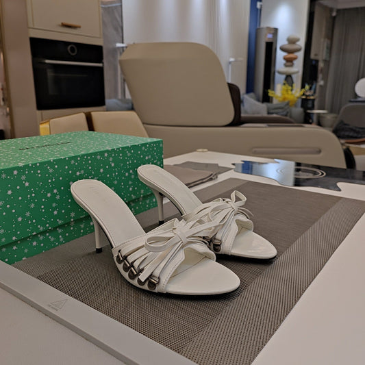 BOW-EMBELLISHED HIGH MULES IN WHITE SHEEPSKIN