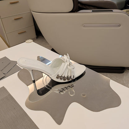 BOW-EMBELLISHED HIGH MULES IN WHITE SHEEPSKIN