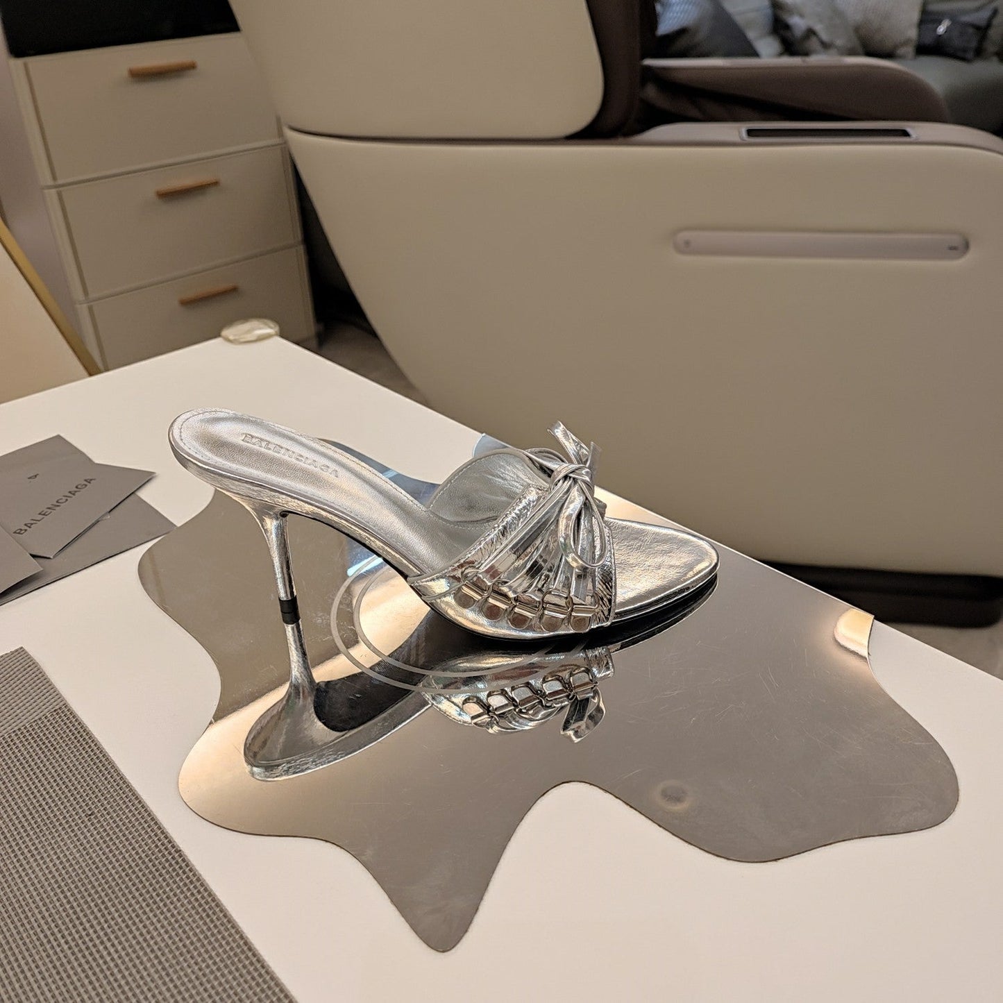 BOW-EMBELLISHED HIGH MULES IN SILVER METALLIC SHEEPSKIN