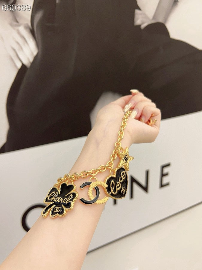 CC BRACELET IN GOLD PLATING CHAIN WITH MULTI CHARM