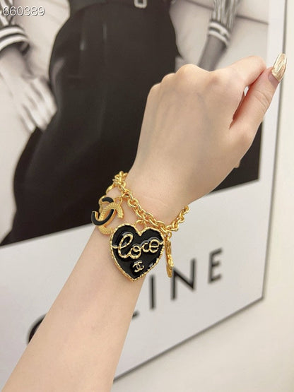 CC BRACELET IN GOLD PLATING CHAIN WITH MULTI CHARM