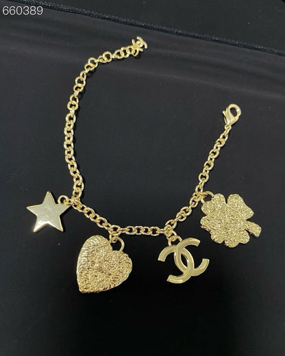 CC BRACELET IN GOLD PLATING CHAIN WITH MULTI CHARM