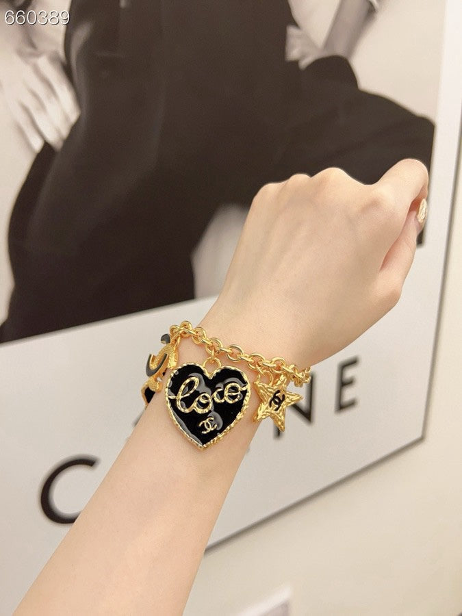 CC BRACELET IN GOLD PLATING CHAIN WITH MULTI CHARM